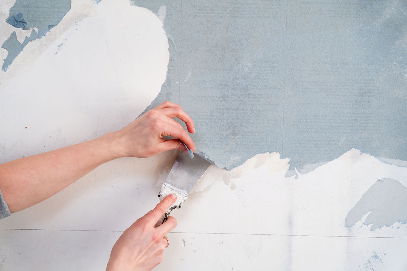removing Wallpaper from the wall with a spatula. with free text